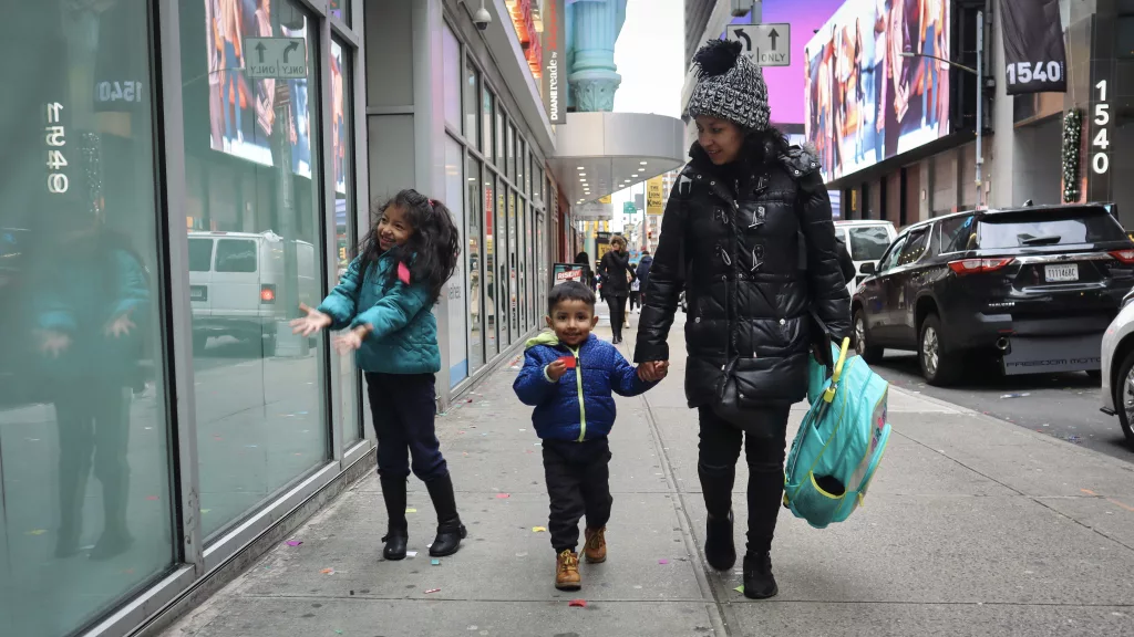 Maria Correa from Ecuador and her two children, Anders and Zhoemi Alquinga, walk to the Roosevelt hotel from the Row NYC on Jan. 4 to inquire about shelter options.