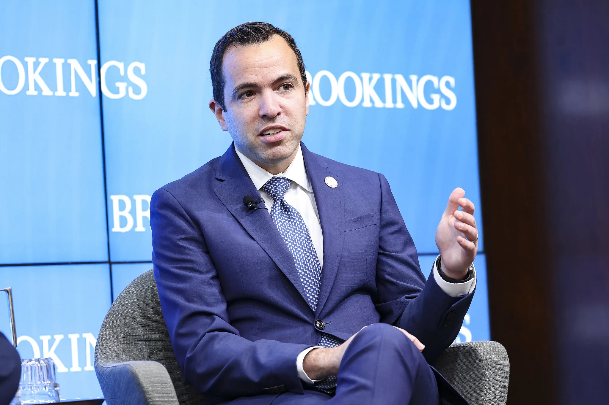 New Jersey Attorney General Matthew Platkin, wearing a navy blue suit, sits and speaks.