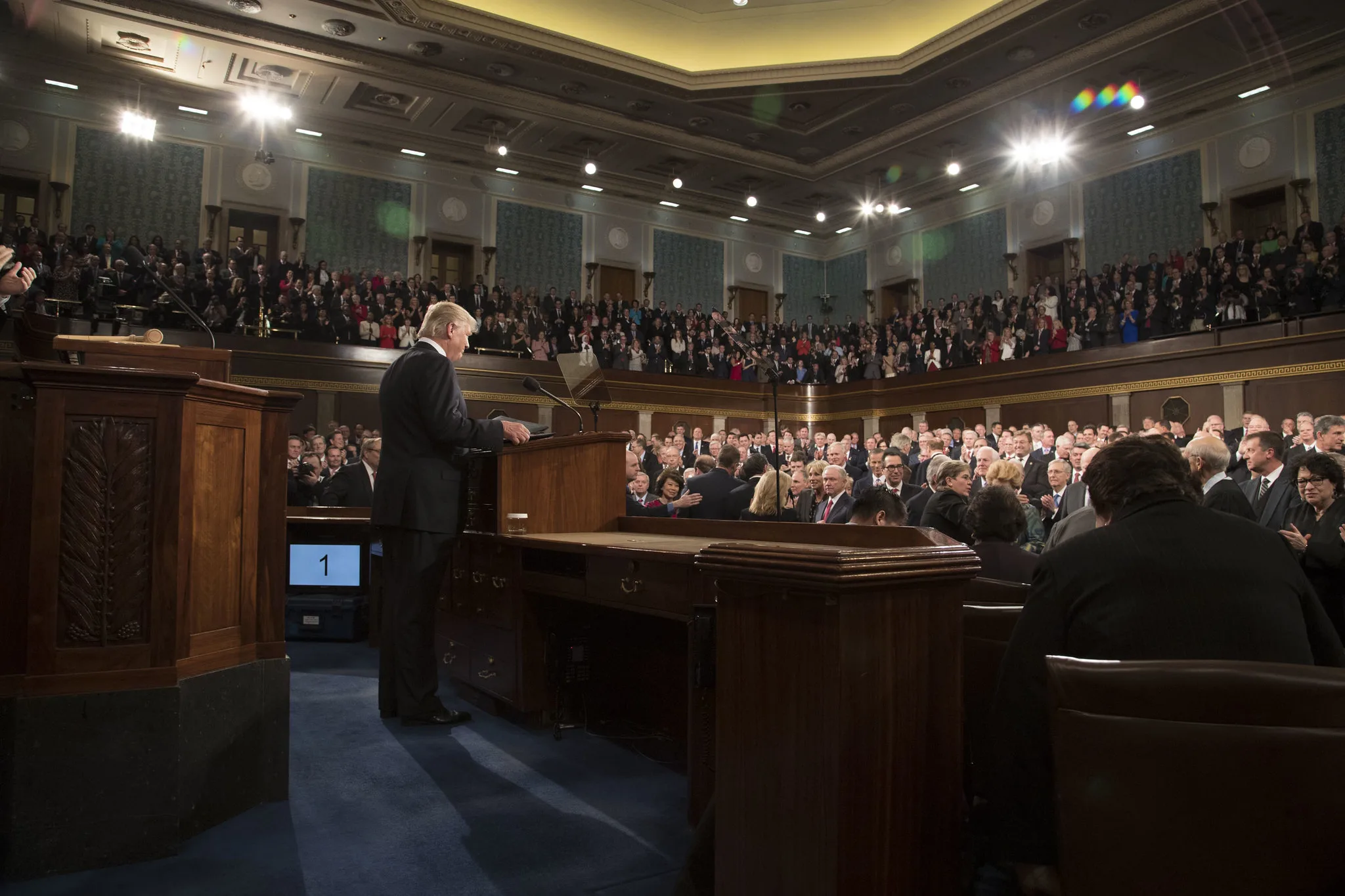 President Trump is viewed from the side as he speaks to hundreds of members of Congress.