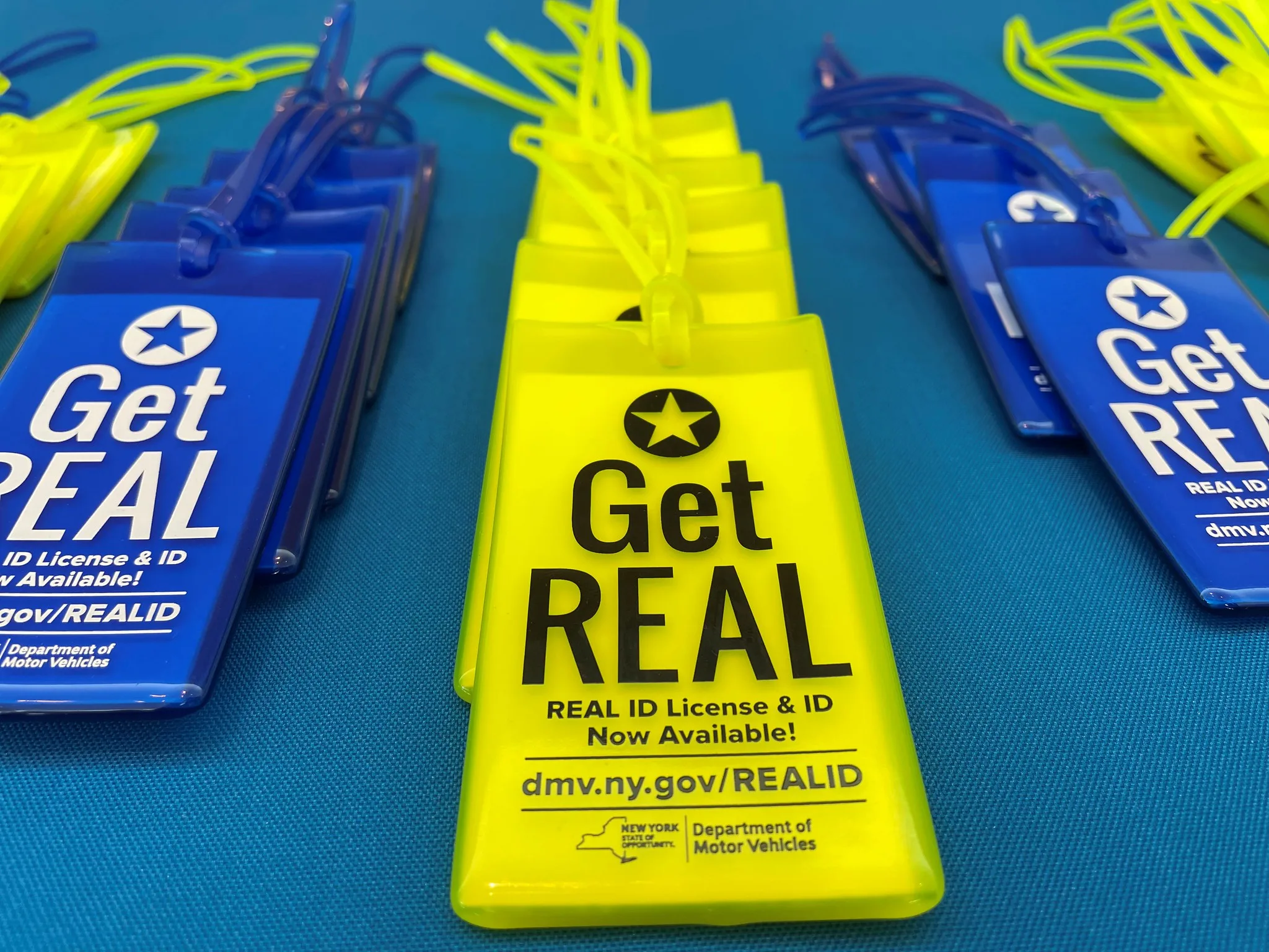 Yellow and blue bag tags that say, 