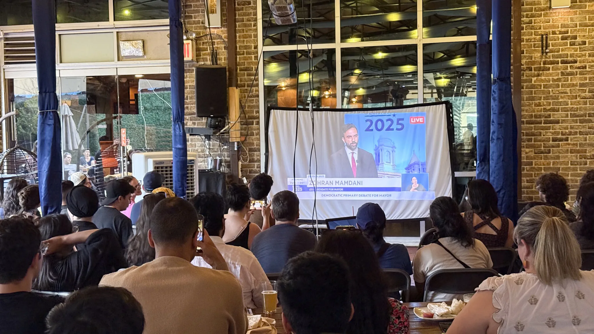 Zohran Mamdani supporters attend debate watch party in Astoria, Queens.