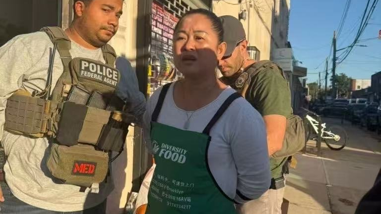 Yibing Wang, a founder of Chimerica Women Association, being handcuffed by officers. Provided to Documented.
