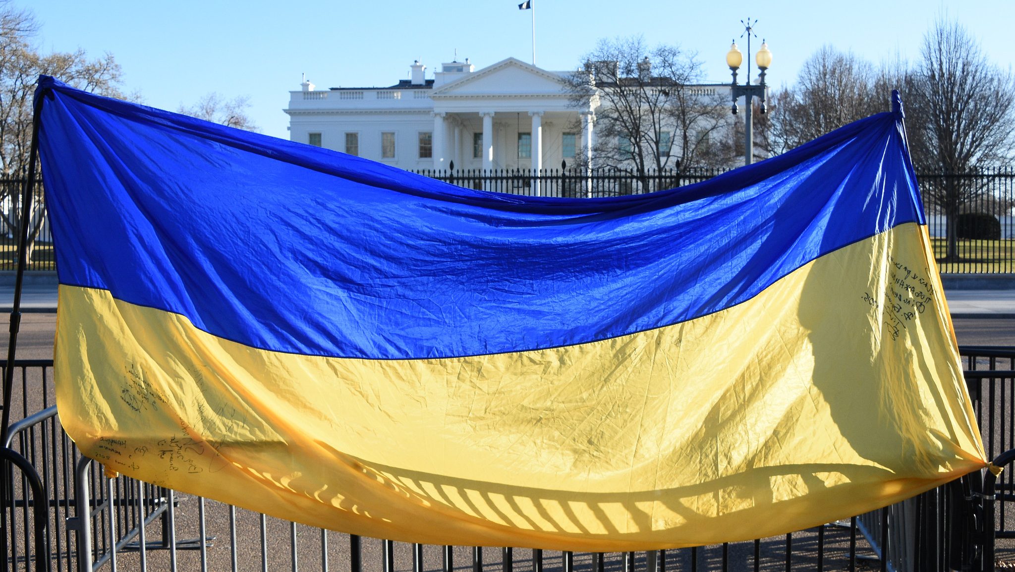 Ukraine flag hangs on the gates in front of the U.S. White House.