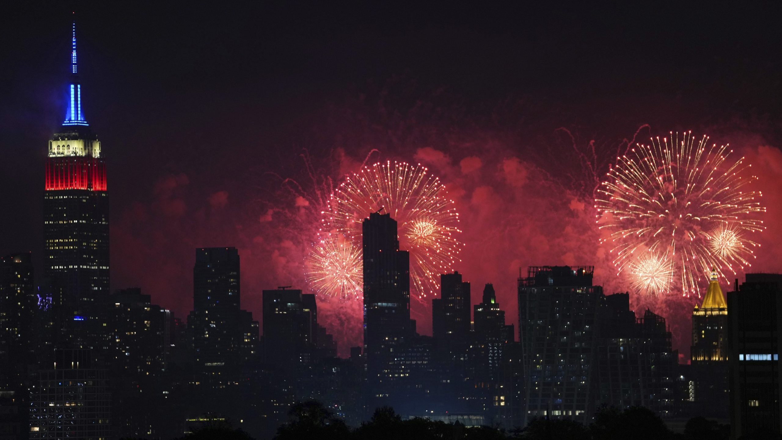 Fireworks explode over the New York City skyline during Macy's 4th of July fireworks display, late Sunday, July 4, 2021, as seen from Jersey City, N.J. (AP Photo/Charles Sykes)