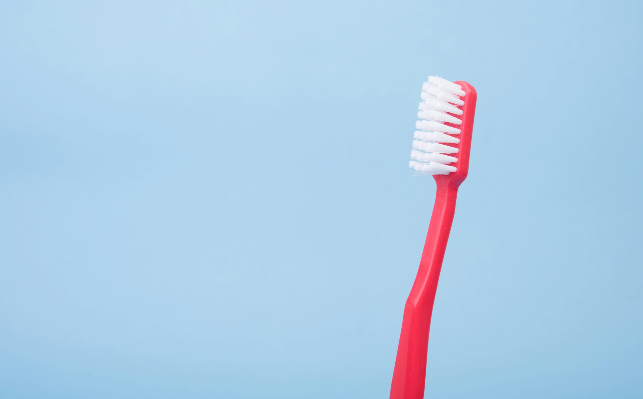 Photo of a red toothbrush.